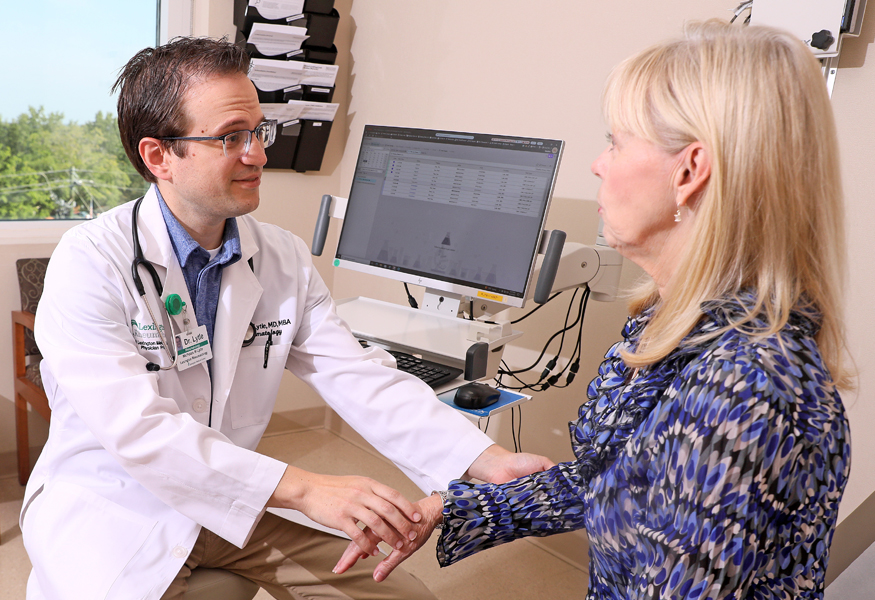 A doctor examining a patient's wrist. 